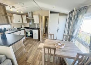a small kitchen with a table and a counter top at Aldbrough Leisure Park in Aldbrough