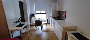 a kitchen and dining room with a table and chairs at Edificio Paradisíaco,Cochabamba in Cochabamba