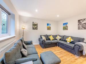 a living room with couches and a couch at The Bunker - Uk47763 in Bamburgh