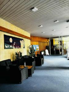 a lobby with couches and tables in a building at Hotel Bezdez Stare Splavy in Staré Splavy