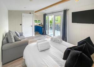 a bedroom with a large white bed and a couch at Watermill Leisure Park in Moortown +31 photos