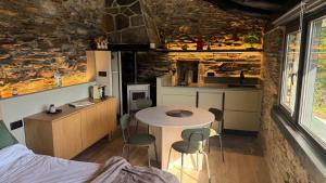 a small kitchen with a table and chairs in a room at Mourulle in Insúa