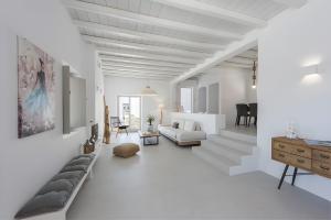 a white living room with a couch and a table at Luxury Complex Ninemia Villas in Faros +73 photos