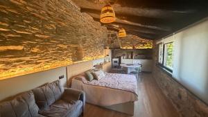 a room with a bed and a couch and a table at Mourulle in Insúa