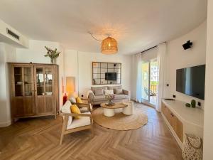 a living room with a couch and a tv at Moraira Castle Boutique Apartment in Moraira