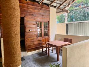a table and chairs on the porch of a house at Leaf Villa in Arugam Bay