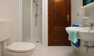 a bathroom with a toilet and a sink and a shower at Villaggio Marina in Bibione