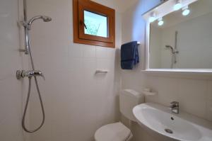 a bathroom with a shower and a toilet and a sink at Villaggio Marina in Bibione +30 photos