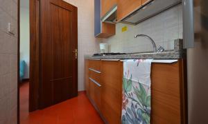 a kitchen with a sink and a counter top at Villaggio Marina in Bibione
