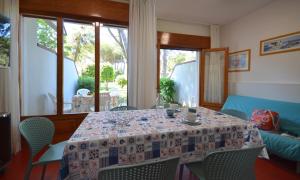 a dining room with a table with a tablecloth on it at Villaggio Marina in Bibione