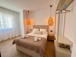 a bedroom with a bed with two towels on it at Moraira Castle Boutique Apartment in Moraira