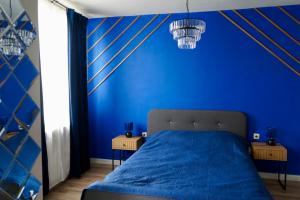 a blue bedroom with a bed and two side tables at Brio boutique hotel in Velingrad +3 photos