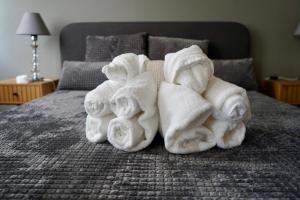 a pile of towels sitting on a bed at Brio boutique hotel in Velingrad