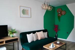 a living room with a green couch and a table at Brio boutique hotel in Velingrad