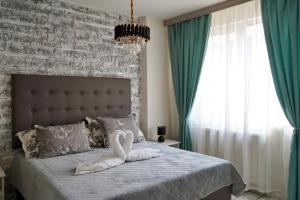 a bedroom with a bed with a swan on it at Brio boutique hotel in Velingrad