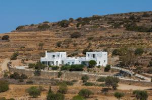 a cluster of white houses on a hill at Luxury Complex Ninemia Villas in Faros
