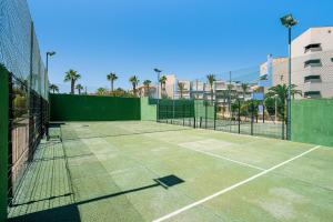 a tennis court with two tennis rackets on it at Aguamarina 2 Sunrise in Orihuela
