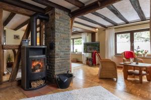 a living room with a brick fireplace and a table at Ferienhaus Rosa in Mechernich