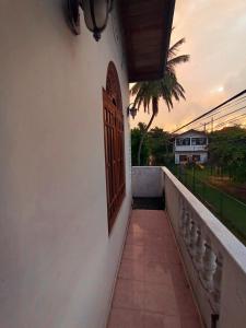 a door on the side of a building with a balcony at 39 House Weligama in Weligama