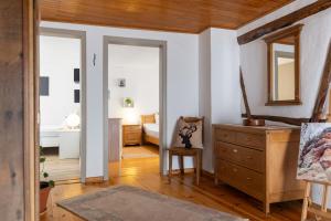 a room with a dresser and a bedroom at Ferienhaus Rosa in Mechernich