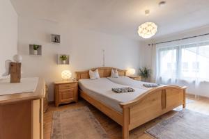 a bedroom with a large bed and a window at Ferienhaus Rosa in Mechernich +9 photos
