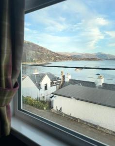 a window with a view of a body of water at Argyll Hotel in Ullapool