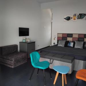 a bedroom with a bed and a table and chairs at Casa Oceanus - Pool Facing Room - Ganpatipule in Nevra
