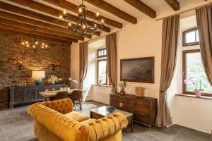 a living room with a couch and a table at Burg Coraidelstein in Klotten