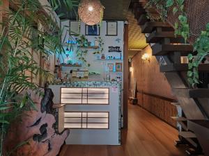 ein Flur mit einer Küche mit Pflanzen an der Wand in der Unterkunft Hostel Caranashi Osaka Imazato in Osaka