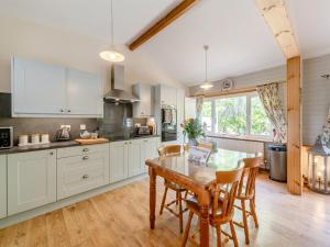 a kitchen with a table and chairs in a room at Captains Quarters - 16266 in Staithes