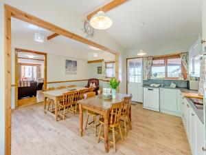 a kitchen and dining room with a table and chairs at Captains Quarters - 16266 in Staithes