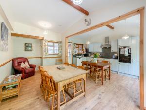 a kitchen and living room with a table and chairs at Captains Quarters - 16266 in Staithes