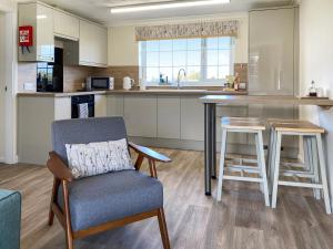 a kitchen with a chair and a table and a counter at Ivy - Uk47373 in Burgh le Marsh
