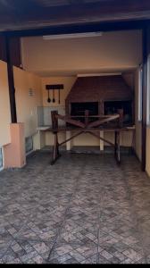 an empty room with a counter and a table at Arcángel san Miguel in Las Toninas