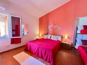 a bedroom with a bed with a red bedspread at La Nuova Rinascita in San Giovanni Suergiu +89 photos