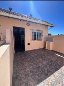 a house with a black door and a courtyard at Arcángel san Miguel in Las Toninas