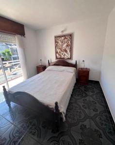a bedroom with a bed and a large window at Arcángel san Miguel in Las Toninas
