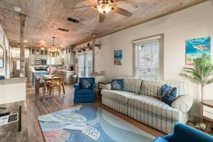 a living room with a couch and a table at Sandy Turtle-Gone to the Beach Be Back Never in Galveston
