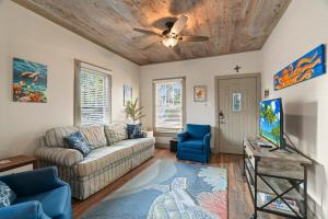 a living room with a couch and a ceiling fan at Sandy Turtle-Gone to the Beach Be Back Never in Galveston