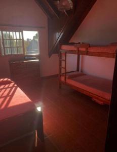 a room with two bunk beds and a window at Arcángel san Miguel in Las Toninas