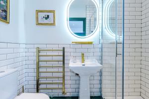 a white bathroom with a sink and a mirror at Godstall Lane Boutique Accommodation in Chester +63 photos
