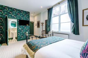 a bedroom with a bed and a large window at Godstall Lane Boutique Accommodation in Chester