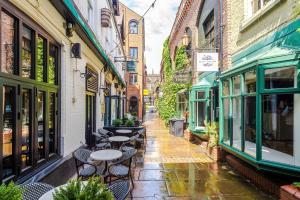 an alley with tables and chairs on a city street at Godstall Lane Boutique Accommodation in Chester