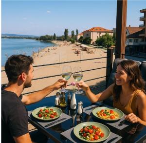 a man and a woman sitting at a table with wine glasses at Hotel Aquastar Danube in Kladovo