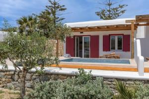 a villa with a pool and a house at Casa Philippi Suites in Mikonos