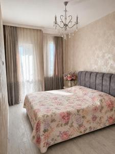 a bedroom with a bed and a chandelier at Gori Palace in Gori