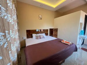 a bedroom with a large bed in a room at Satvik Homestay in Devgarh +14 photos