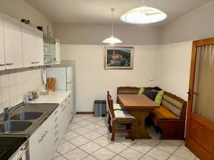 a kitchen with a table and a couch in a room at Apartma Danijela in Kanal +8 photos