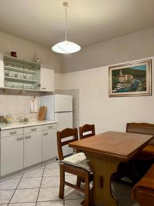 a kitchen with a table and a refrigerator at Apartma Danijela in Kanal