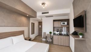 a hotel room with a bed and a dining room at Hotel Luxor Florence in Florence